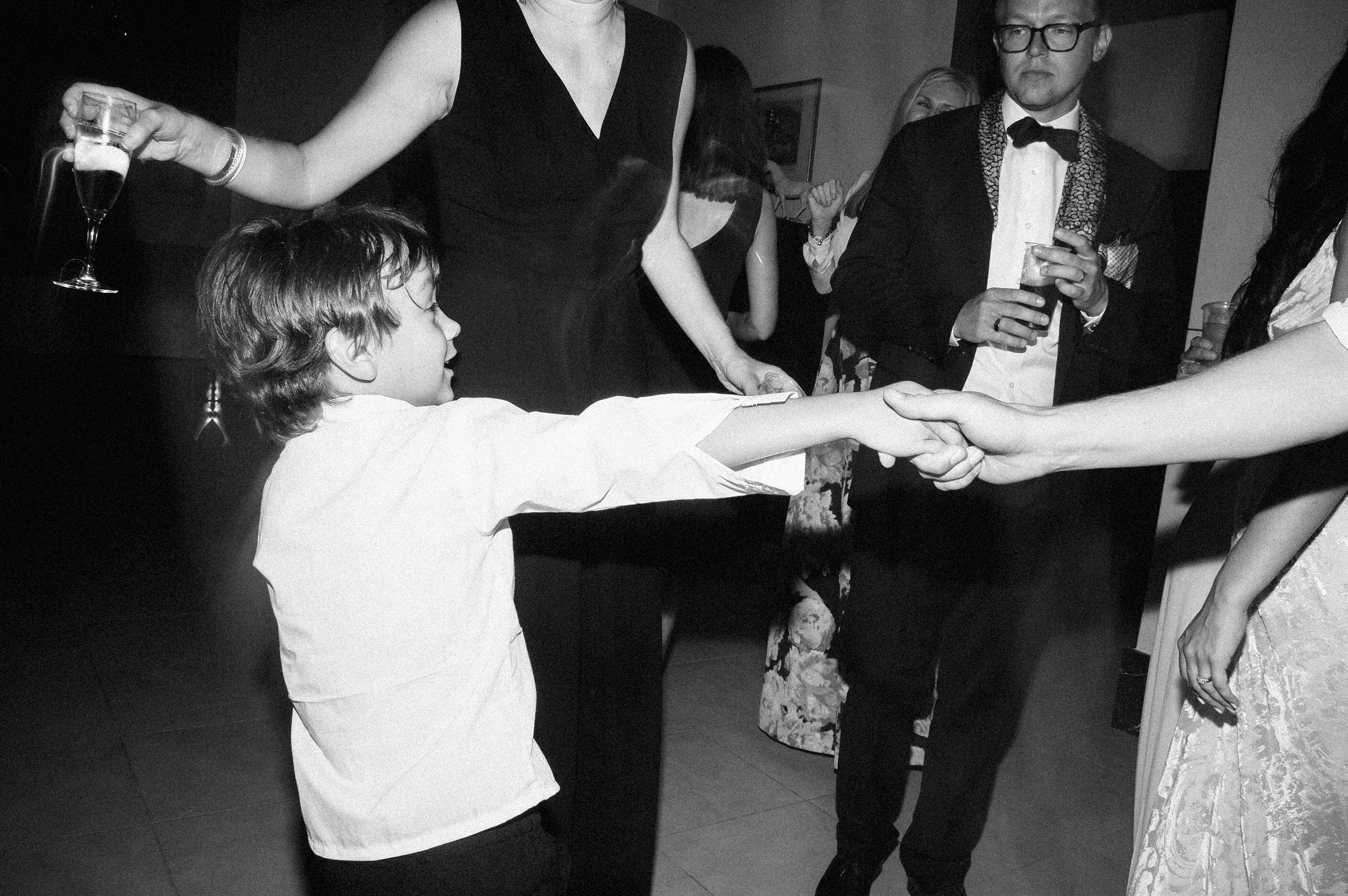 kid dancing during reception black and white 60s style black and white wedding photography