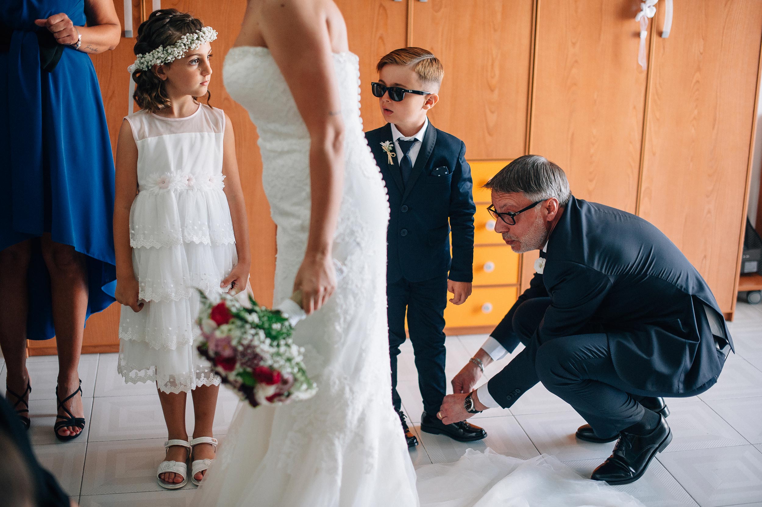 street photography wedding in naples boy and girl stare at the bride getting ready