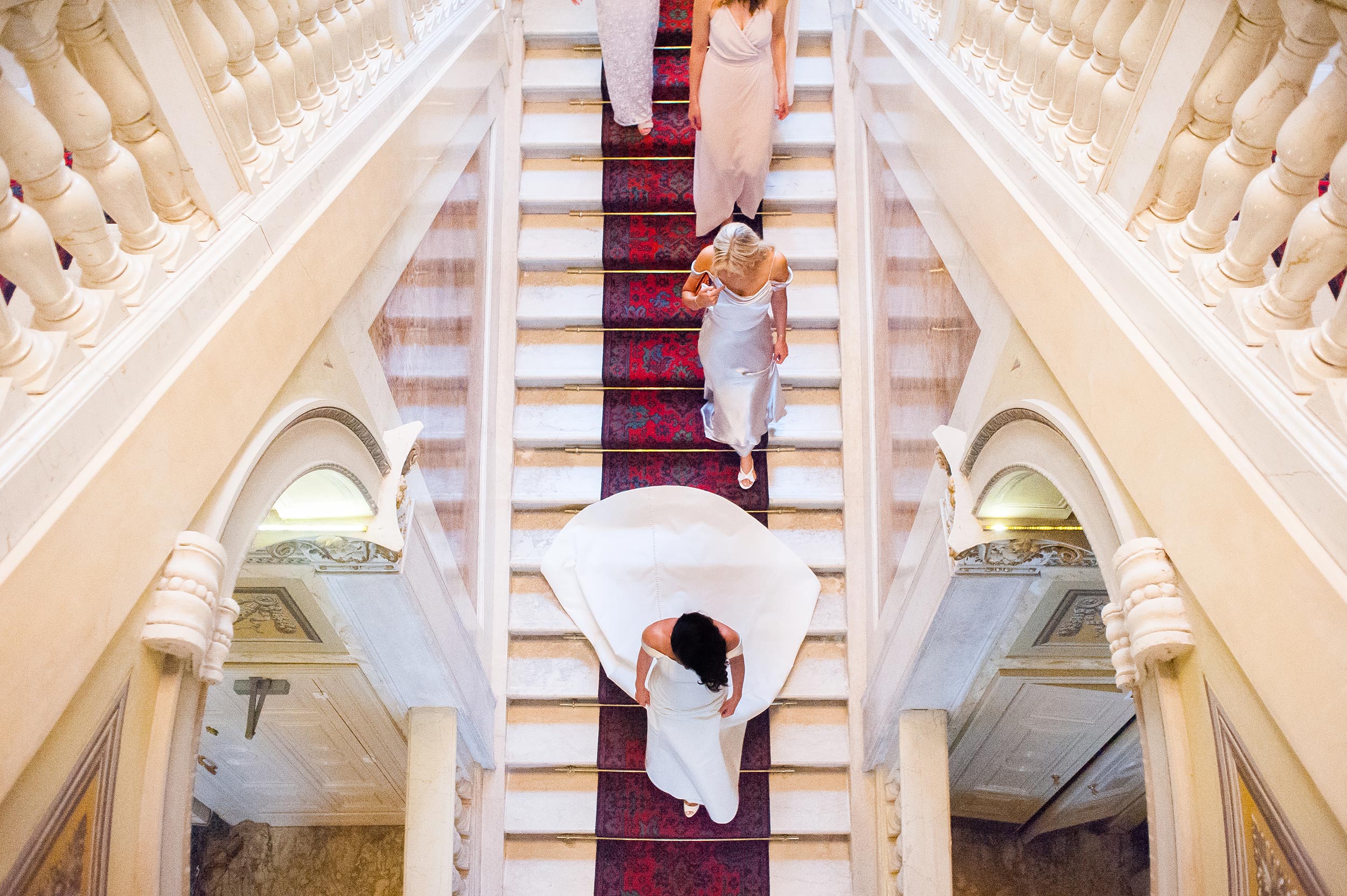 wedding in lake como bride and bridal party coming down the steps symmetry wes anderson