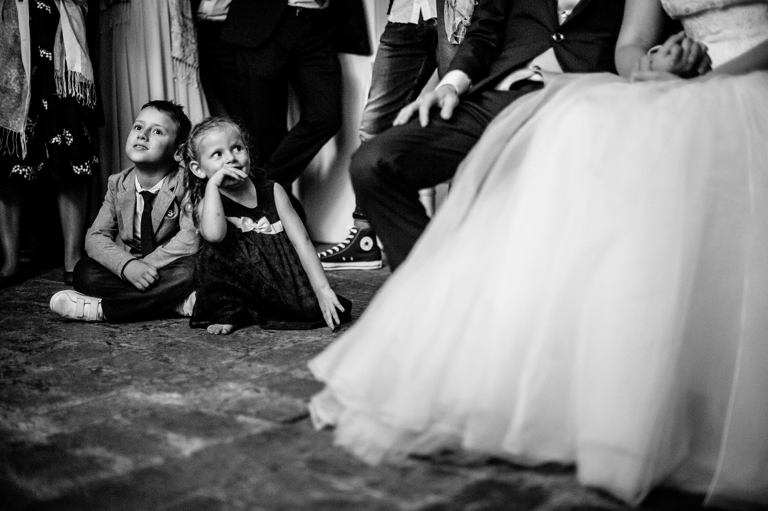 girl stares at the bride dreaming during short movi projection black and white wedding photography