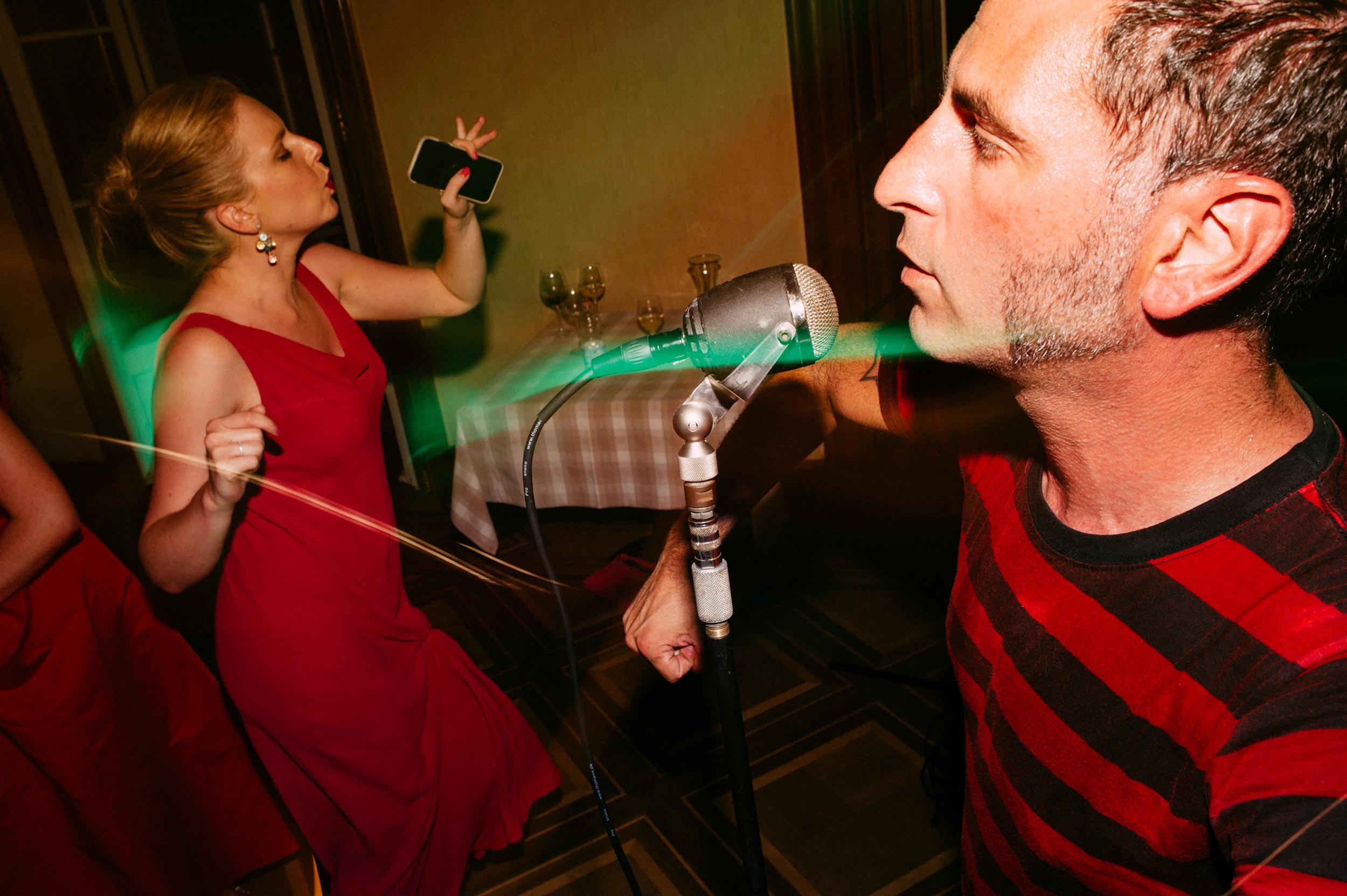 woman dancing while guitarist play at wedding reception
