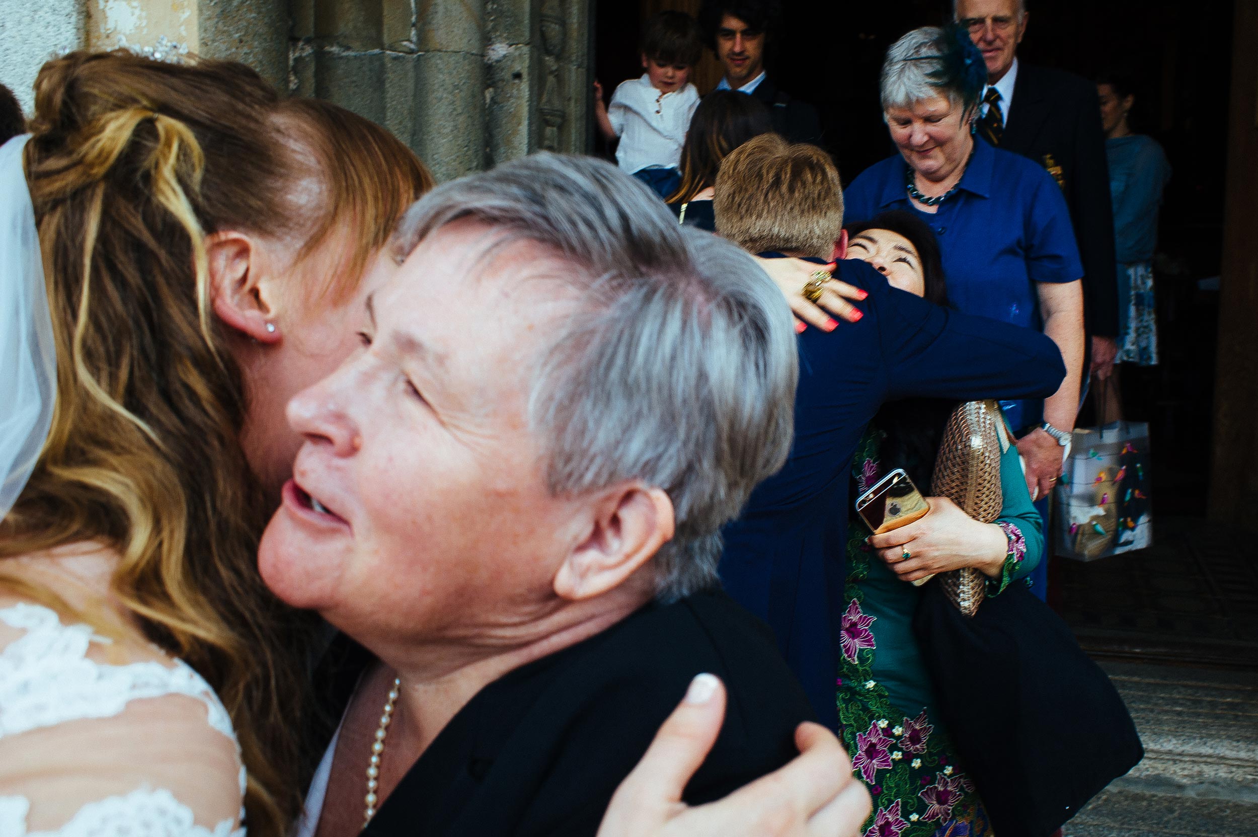 bride and groom kissing people outside the church wedding lake orta italy