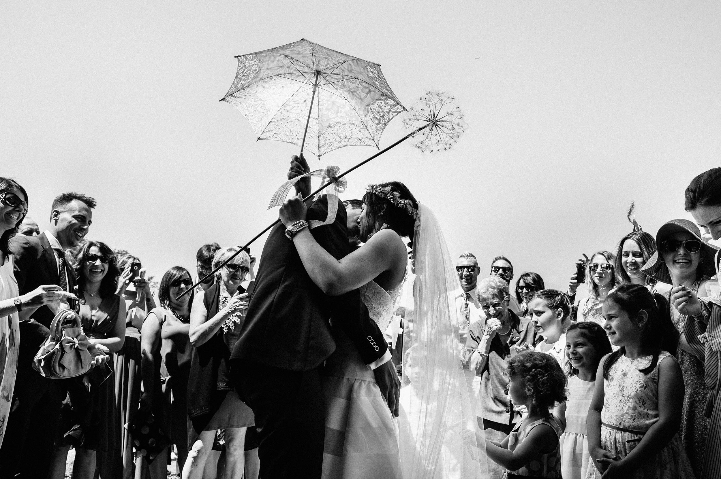 bride and groom kissing outside the church black and white wedding photography