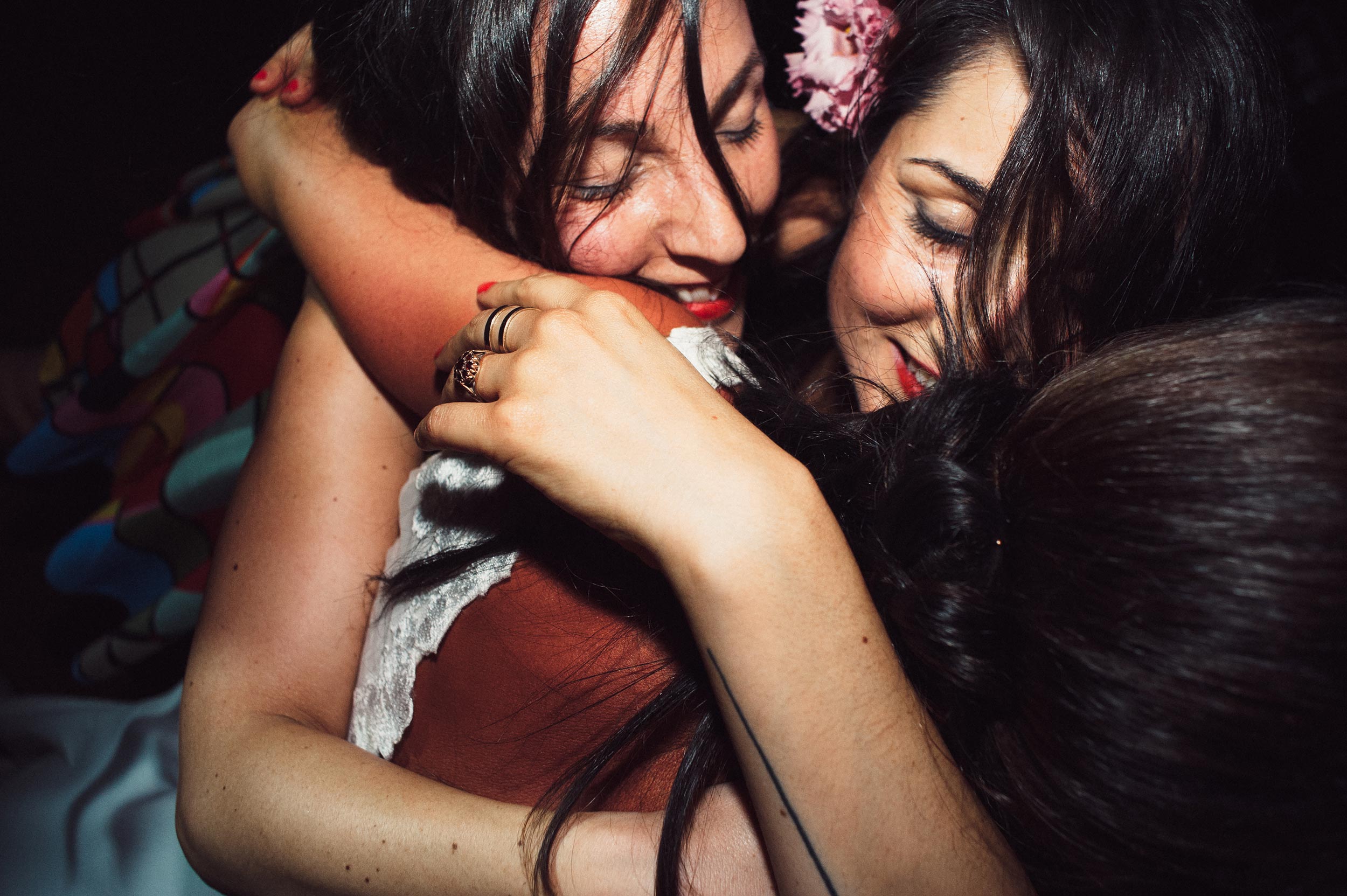 brides best friends embrace during wedding reception