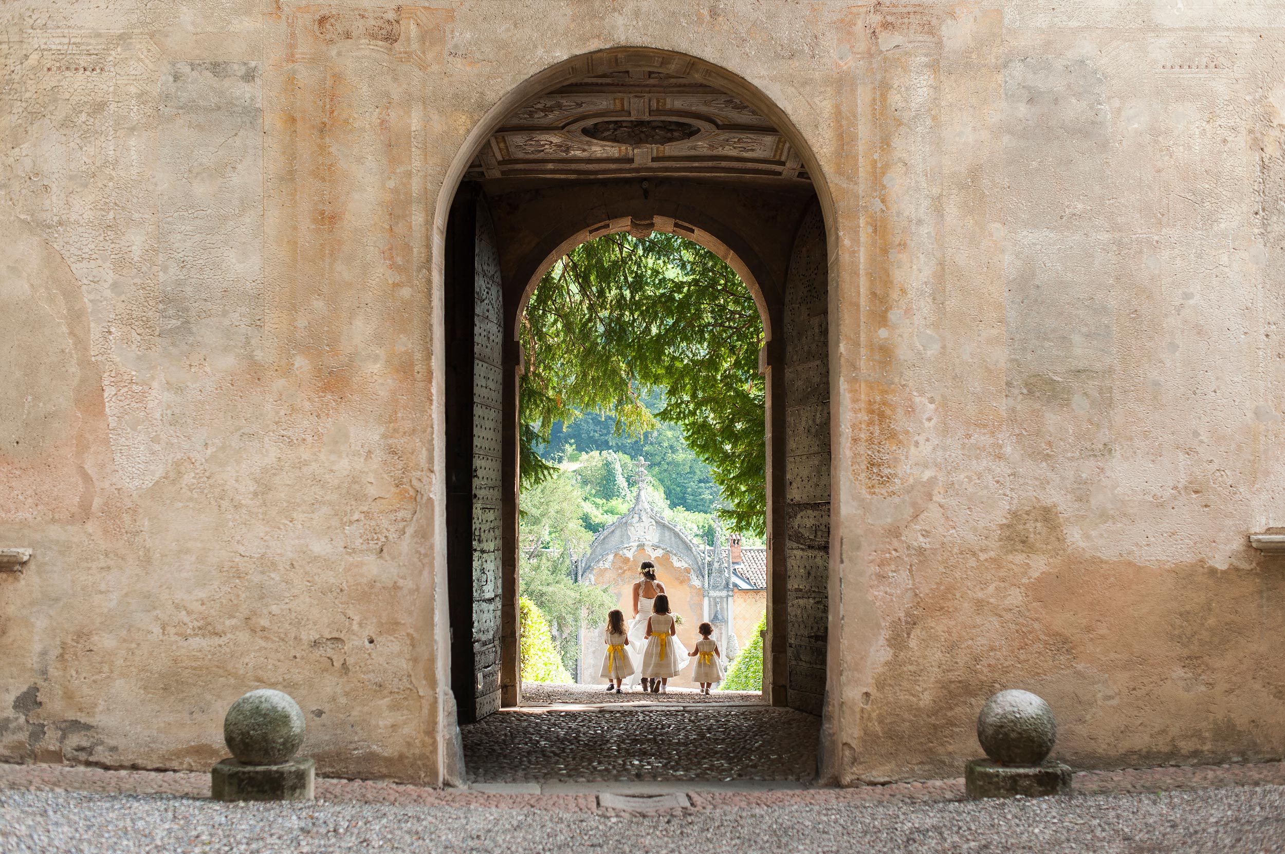 girls escort the bride towards the ceremony