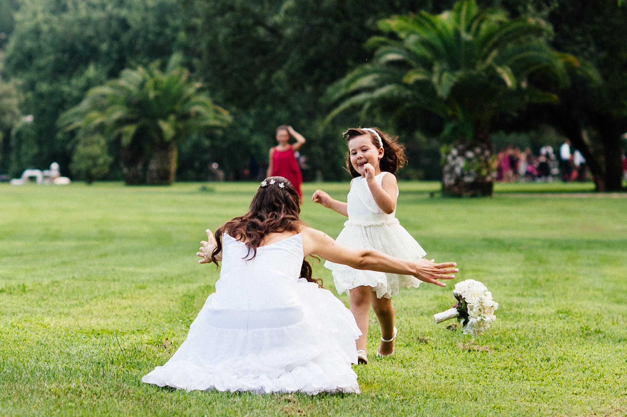 girl runs in front of the bride and she drops the bouqut