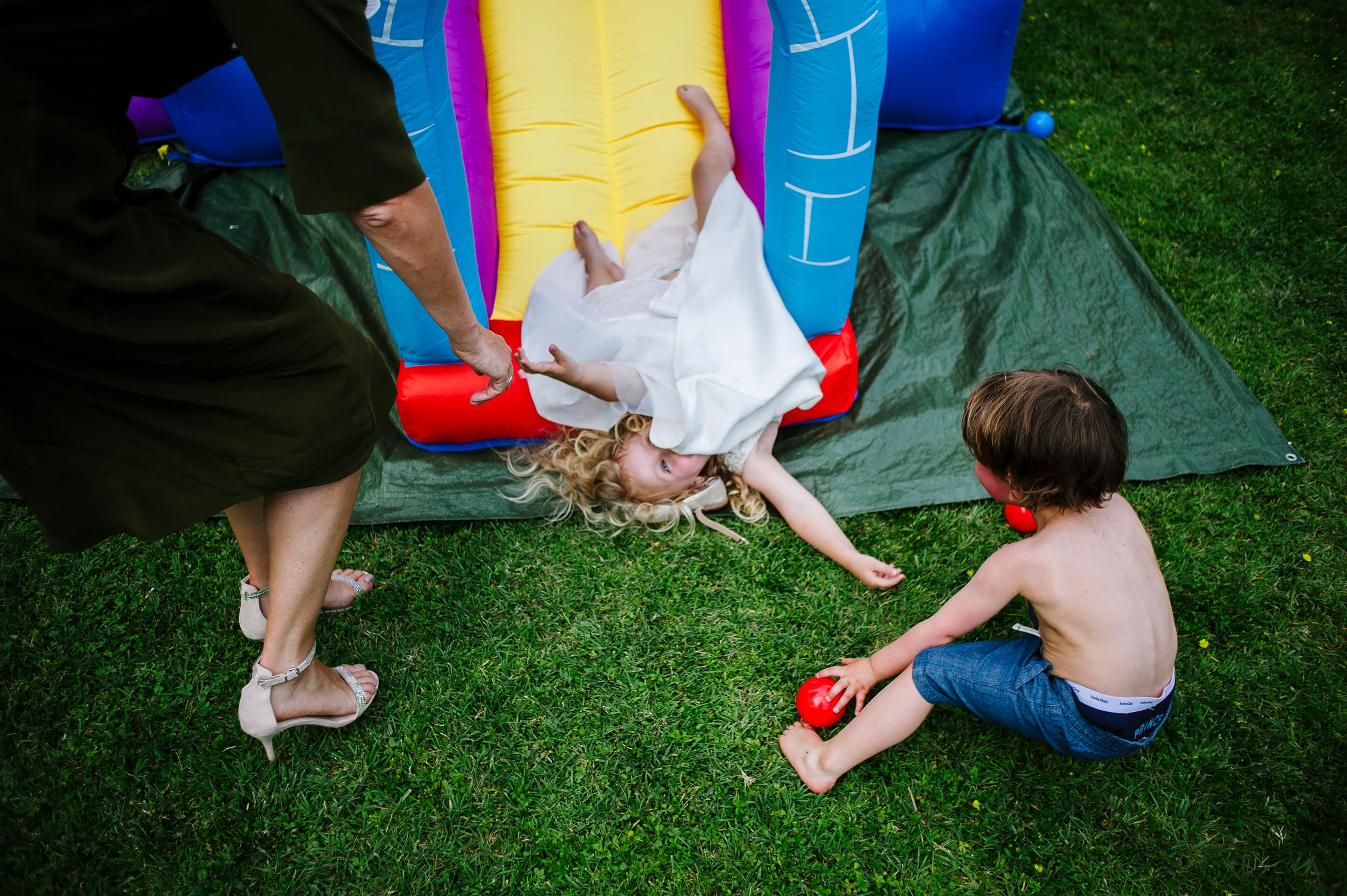 girl falling from an inflatable slide