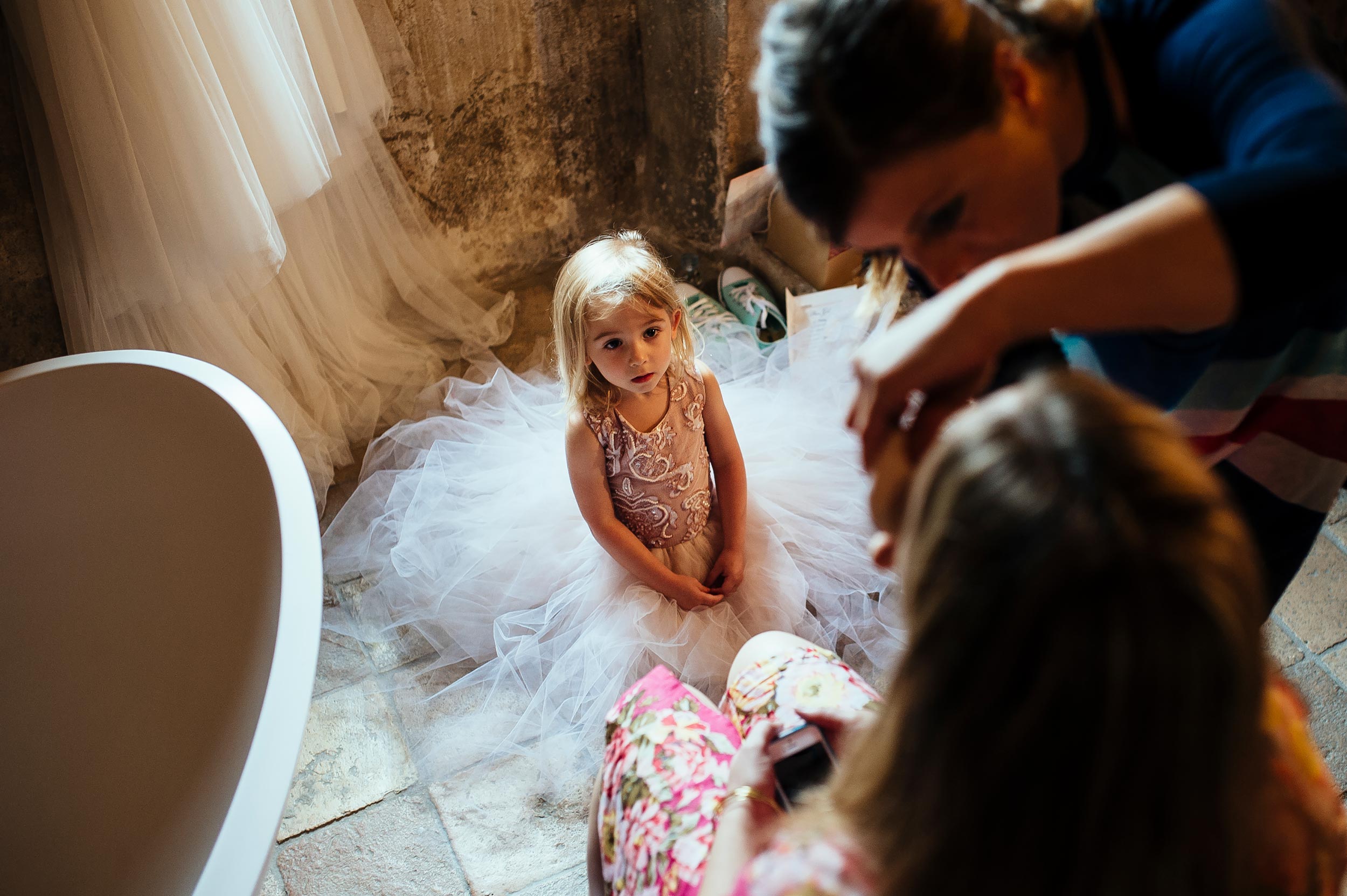 girl looking ad the bride while getting ready at makeup wedding in italy