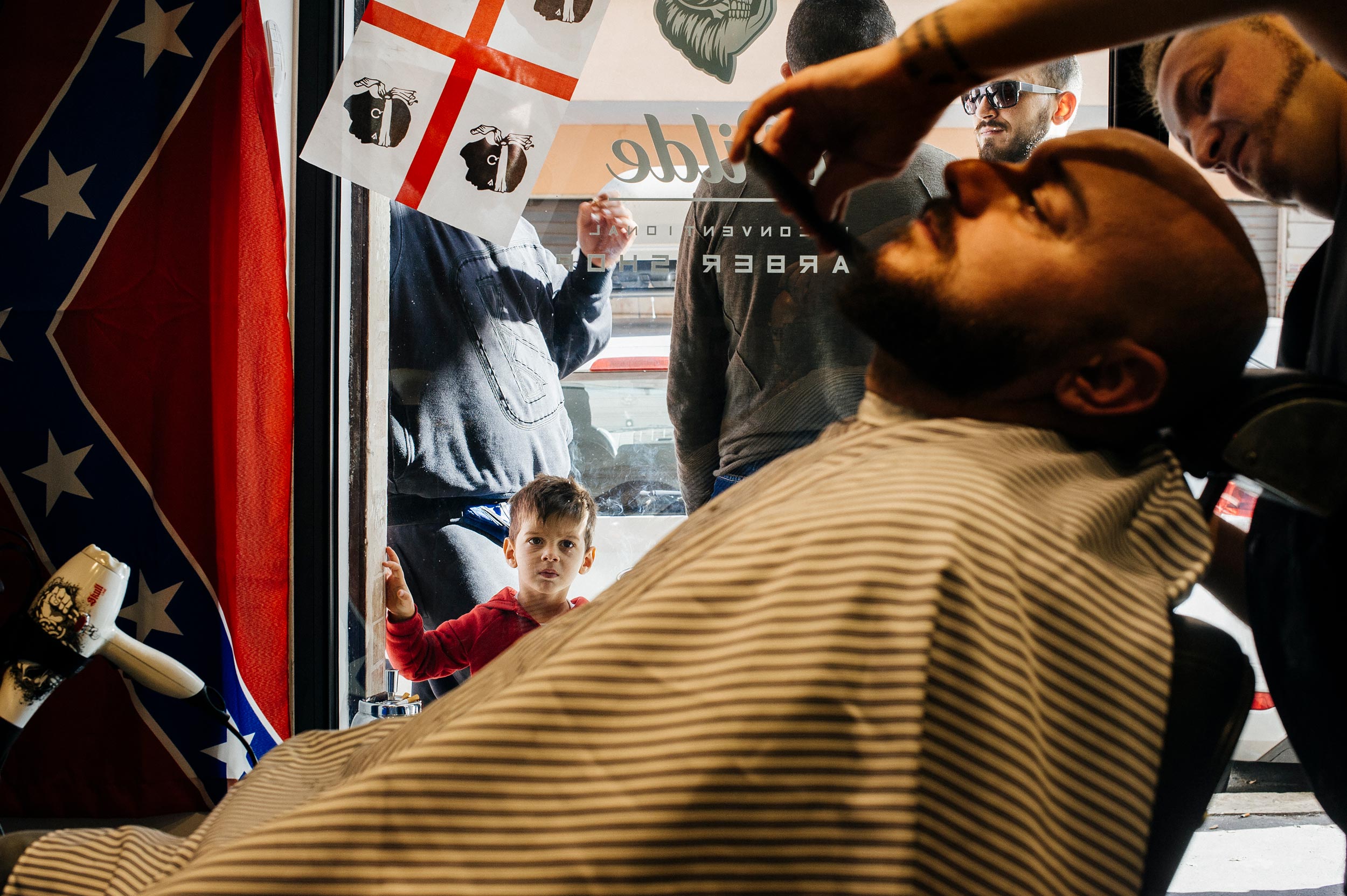 kid watches groom in the barbershop