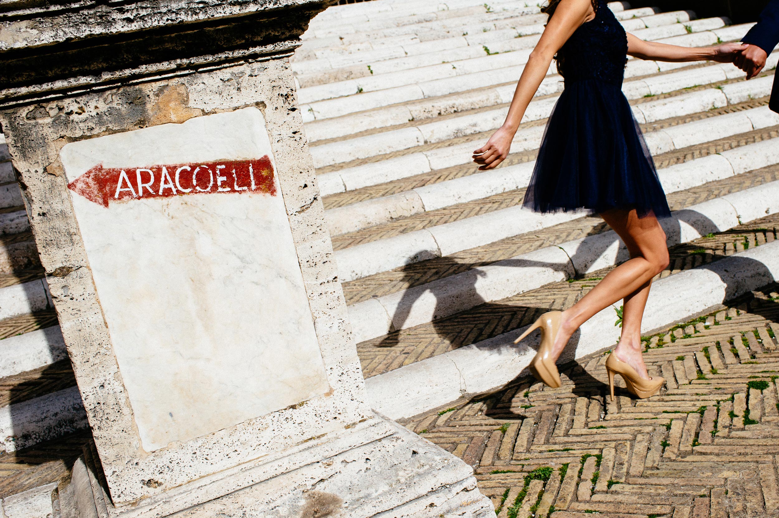 Engagement in Rome - couple running up Ara Coeli steps