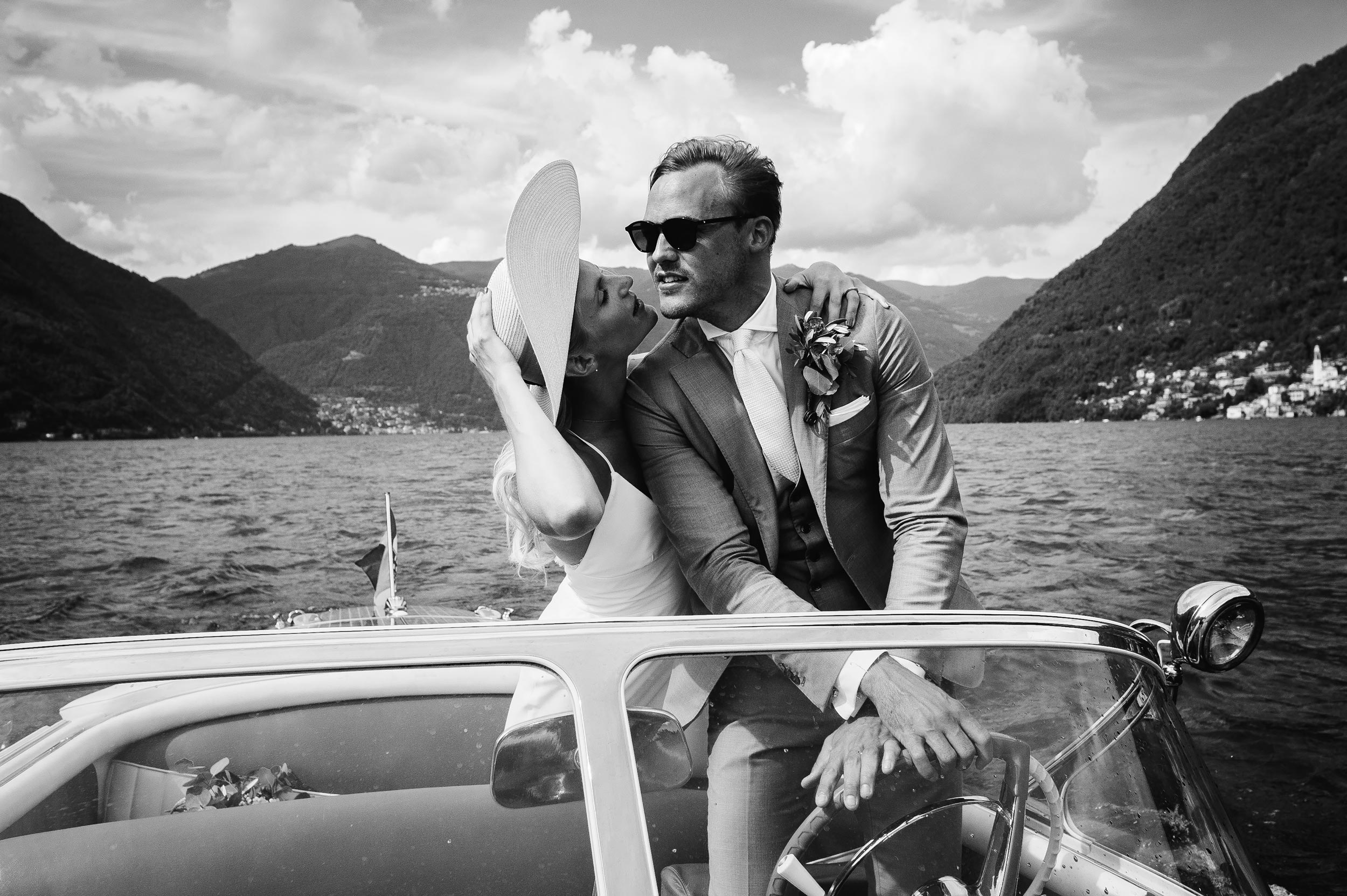 lake como wedding photographer Alessandro Avenali bride and groom driving riva yacht motorboat black and white