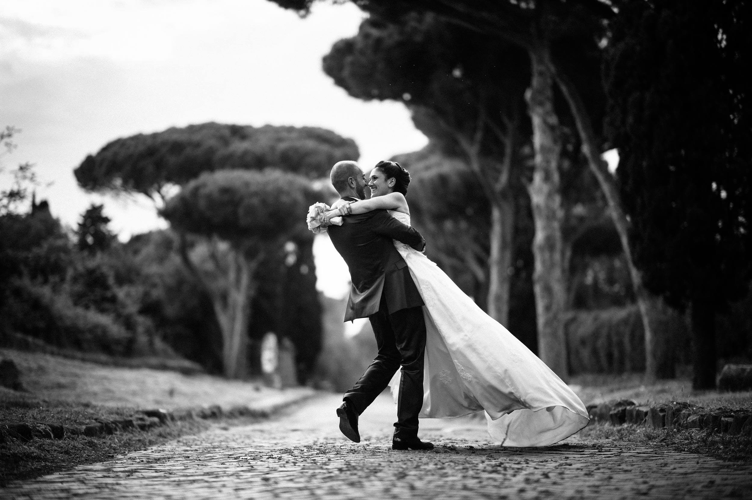 via appia antica bride and groom holding and dancing black and white wedding photography