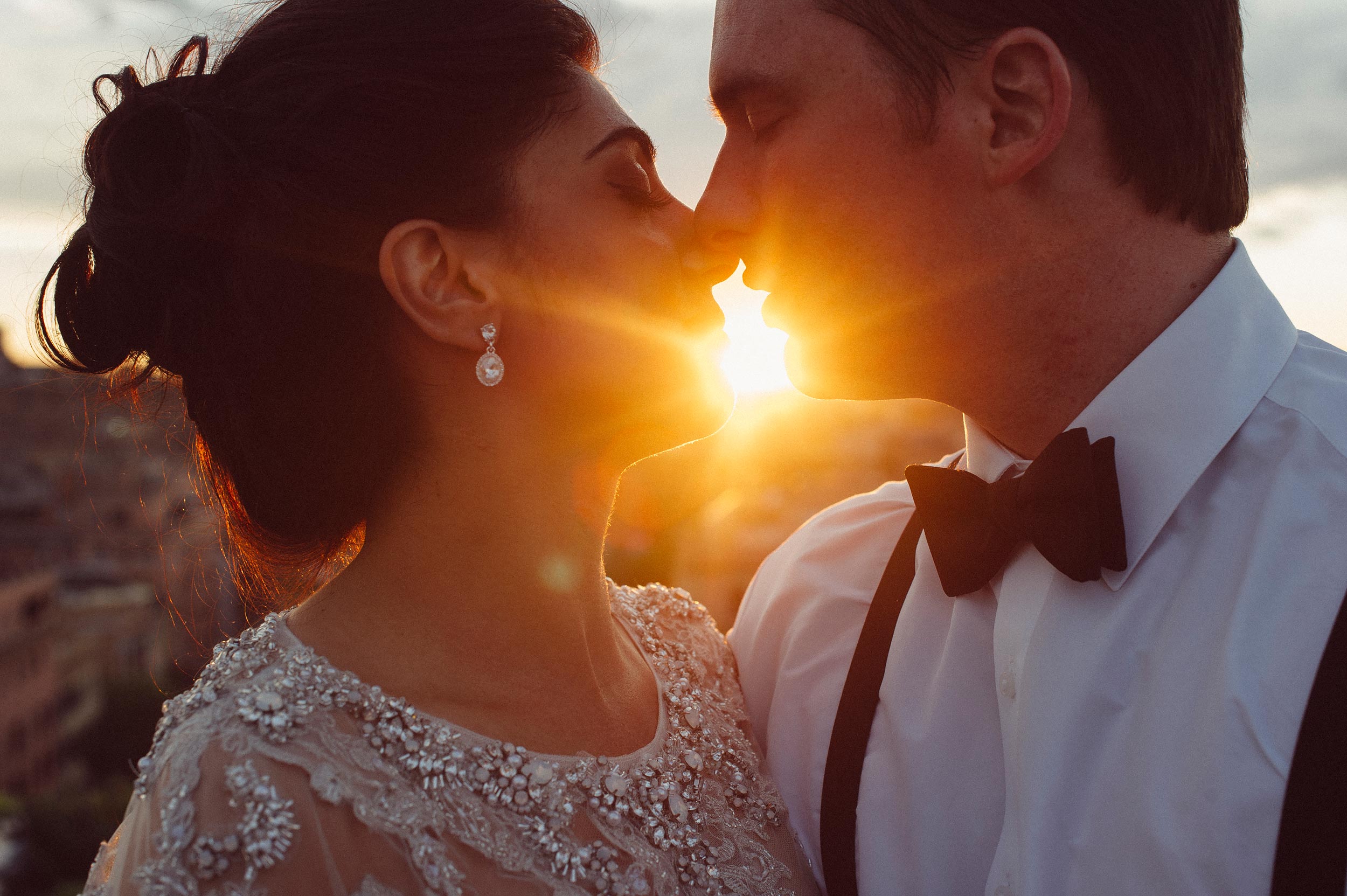 bride and groom kissing at sunset in rome vatican